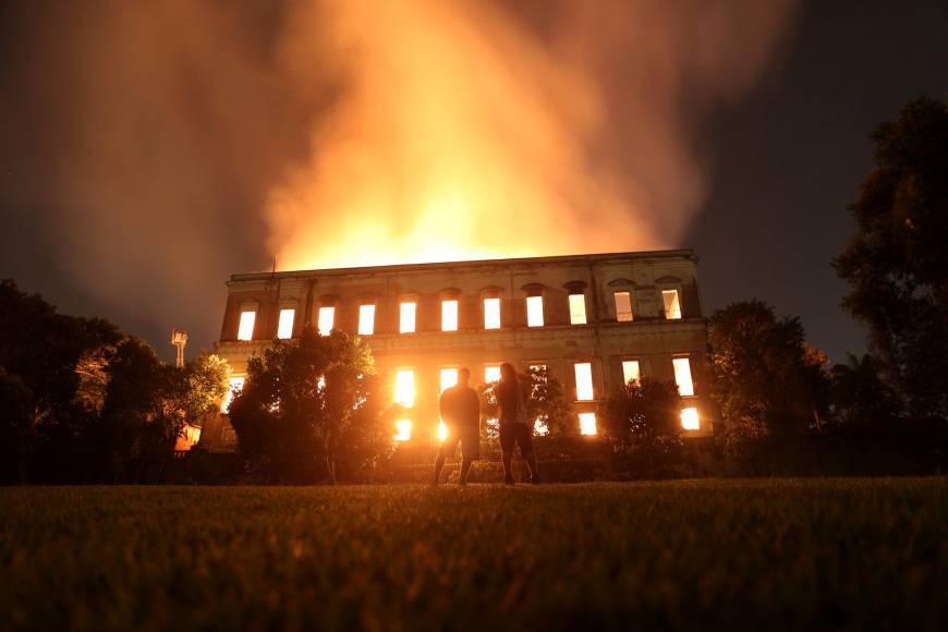 People watch as a fire burns at the National Museum of Brazil in Rio de Janeiro on Sunday. Raging fire tears through treasured National Museum in Rio de Janeiro, causing ‘irreparable’ loss