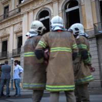 Firefighters and Federal Police members talk in front of Rio de Janeiro’s treasured National Museum, one of Brazil’s oldest, on Monday, two days after a massive fire ripped through the building. Brazilian officials on Monday blamed years of government cutbacks for an inferno that gutted the treasured National Museum, described by President Michel Temer as a “tragic” loss of knowledge and heritage. Bone fragments found in gutted, smoldering Rio museum provide some hope