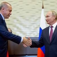 Russian President Vladimir Putin shakes hands with Turkish President Recep Tayyip Erdogan during their meeting in the Bocharov Ruchei residence in the Black Sea resort of Sochi, Russia, on Monday. Turkey and Russia agree on demilitarized zone in Syria's Idlib