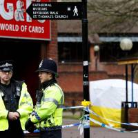 Police officers stand on duty at a cordon near a bench covered in a protective tent at The Maltings shopping center in Salisbury, England, in March. There is “nothing to suggest” that Novichok caused two people to fall ill in the British town where a Russian ex-spy and his daughter were poisoned by the deadly nerve agent, police said Monday. No link to Sergei Skripal poisoning in new Salisbury scare: U.K. police