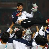 South Korea’s Son Heung-min celebrates with the team after they defeated Japan to win the men’s soccer gold medal match at the 18th Asian Games in Bogor, Indonesia, on Saturday. South Korea may seek change in controversial military exemption for athletes