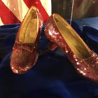 A pair of ruby slippers once worn by actress Judy Garland in the “The Wizard of Oz” are displayed at a news conference Tuesday at the FBI office in Brooklyn Center, Minnesota. Authorities announced that the slippers, stolen in 2005 from the Judy Garland Museum in Grand Rapids, Minnesota, were recovered in a sting operation. The FBI says it has multiple suspects in the extortion and that the investigation continues. Four pairs of ruby slippers worn by Garland in the movie are known to exist. Judy Garland’s name can be seen in the shoe at right. Stolen 'Wizard of Oz' slippers found after 13 years