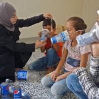 Um Majid tries an improvised gas mask on familiy members in her home in Binnish in Syria’s rebel-held northern Idlib province as part of preparations for any upcoming raids on Wednesday. The Syrian regime and its Russian ally are threatening an offensive to retake the northwestern province of Idlib, Syria’s last rebel bastion. U.N. documents further Syrian regime use of banned chemical arms, fears Idlib 'massacre'