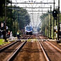 Members of the emergency services investigate the scene of a train crash with a cargo bike on a rail crossing in Oss, Netherlands, on Thursday that killed four children and severely injuring another child and an adult. 'Worst nightmare': Dutch train kills four kids in electric cart on crossing