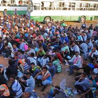 Migrants are seen after they were relocated from government-run detention centers, after getting trapped by clashes between rival groups in Tripoli Tuesday. Hundreds of African migrants flee detention center amid Tripoli bloodshed: aid official