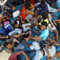 Illegal migrants sit inside the Ganzour shelter after being transferred from in the airport road due to fighting in the Libyan capital Tripoli on SWednesday. The UN mission in Libya said it brokered a cease-fire to end a week of clashes in the capital Tripoli that have killed dozens and forced thousands to flee their homes. The U.N. rights office expressed concern about the impact on vulnerable people, including migrants. “Some of the nearly 8,000 arbitrarily detained migrants are trapped in detention centers in areas where fighting has been taking place, without access to food or medical treatment,” said spokeswoman Elizabeth Throssel. Migrants rescued in Mediterranean must not be sent back to Libya, where they face serious abuses: UNHCR