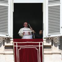 An assistant adjusts the microphone as Pope Francis prepares to deliver his blessing during the weekly Angelus prayer on Sunday at St. Peter’s square in the Vatican. Vatican expels suspended Chilean priest accused of sexual abuse
