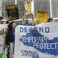 Supporters of temporary protected status of immigrants cheer, hold signs and a banner with the outline of El Salvador at a rally at a federal courthouse in San Francisco, the day a lawsuit was filed against the Trump administration over its decision to end a program that lets immigrants live and work legally in the United States, in March. During a hearing on Tuesday, U.S. District Judge Edward Chen questioned the Trump administration’s motives to end the program and repeated the president’s vulgar language to describe some countries during a White House meeting in January. U.S. judge repeats Trump vulgarity toward African nations during immigration hearing
