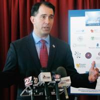 Wisconsin Gov. Scott Walker speaks at a news conference in Madison Jan. 30. Walker faces Democrat Tony Evers in the November election. Walker’s first attack ad of the gubernatorial race released Wednesday refers to a sex act while accusing Evers, the state superintendent, of not revoking the license of a teacher who viewed pornographic images on a school computer. On Trump cue, GOP incumbent Scott Walker urges standing, not kneeling, during national anthem
