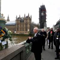 Members of the public pay their respects on Westminster Bridge on March 22 on the anniversary of the terror attack in London. 'Lives torn apart in 82 seconds,' U.K. Westminster attack inquest hears