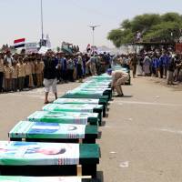 Mourners attend a funeral of people, mainly children, killed in a Saudi-led coalition airstrike on a bus in northern Yemen, in Saada Aug. 13. Saudi-led airstrike that left at least 51 dead on bus in Yemen is 'apparent war crime'