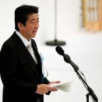 Prime Minister Shinzo Abe attends a memorial service ceremony marking the 73rd anniversary of Japan’s surrender in World War II, at the Nippon Budokan hall in Tokyo on Aug. 15. Abe says in interview that Japan's ties with China back to 'normal track'