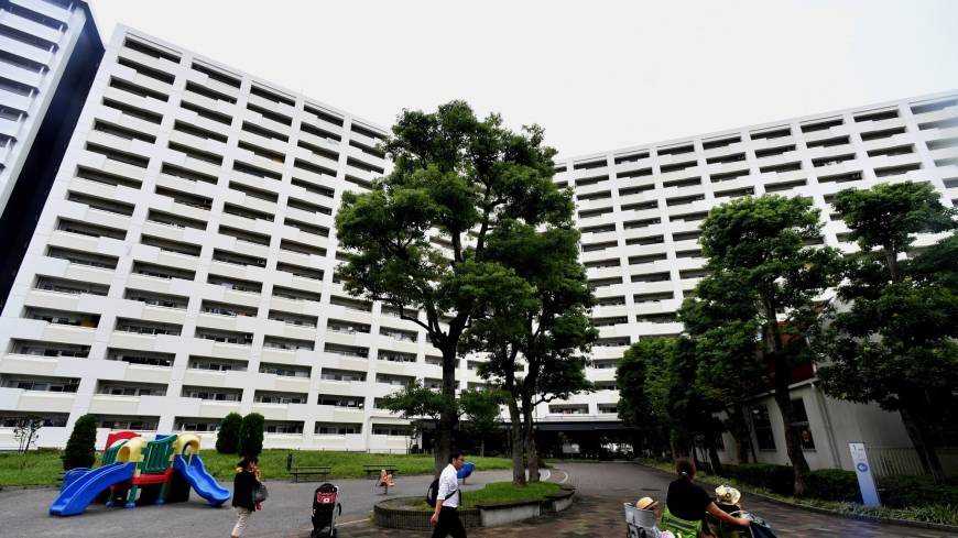 Residents make their way through the courtyard of giant public housing unit Shibazono Danchi in Kawaguchi, Saitama Prefecture, on Friday. The unit’s demographic mainly consists of young, foreign families and elderly Japanese. Japan's 'danchi': Public housing blocks highlight the complexity of interculturalism