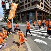 Runners participate in the Run Tomo event, held Sunday in the city of Chiba to raise awareness toward creating a dementia-friendly community across Japan. The event will be extended to other cities through November. Run Tomo event takes steps toward building a dementia-inclusive Japan