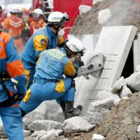 A police officer uses a cutter on a concrete slab during a disaster drill on Saturday in Kawasaki. Disaster drill held to prepare for feared Nankai Trough quake