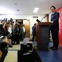 Prime Minister Shinzo Abe, who is also leader of the ruling Liberal Democratic Party, attends a news conference after winning the party’s presidential election at LDP headquarters in Tokyo on Thursday. U.S. experts laud Abe on election win but warn against pushing for constitutional amendment