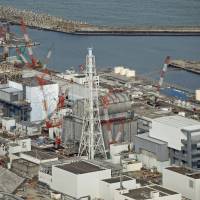 The crippled Fukushima No. 1 nuclear plant is seen from the sky in February. Fukushima considers action against Netflix over 'Dark Tourist' video of 3/11 hot zone