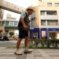 Former professional boxer Iwao Hakamada, who was sentenced to death for the murder of four members of a family in 1966, walks along a street in Hamamatsu, Shizuoka Prefecture, on Aug. 28. Free pending retrial, Japanese boxer sentenced to death keeps up the good fight