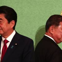 Prime Minister Shinzo Abe (left) and former Defense Minister Shigeru Ishiba attend a debate for the Liberal Democratic Party presidential election at the Japan National Press Club in Tokyo on Friday. Abe-Ishiba debate highlights candidates' lack of concrete plans to tackle fundamental problems
