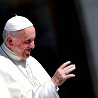 Pope Francis waves to the faithful during the weekly general audience in Saint Peter’s square, Vatican, on Wednesday. Pope says he hopes to visit Japan next year, fulfilling wish