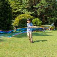 Prince Hisahito, the only son of Prince Akishino and Princess Kiko, makes soap bubbles on the grounds of the Akasaka Estate in Tokyo on Aug. 10. Prince Hisahito, grandson of Emperor Akihito and third in line to the throne, turns 12