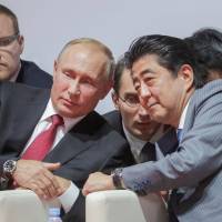 Russian President Vladimir Putin and Prime Minister Shinzo Abe attend an international judo tournament on the sidelines of the Eastern Economic Forum in Vladivostok, Russia, on Wednesday. Russia offers Japan time to consider Vladimir Putin's unexpected peace treaty proposal