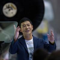 Yusaku Maezawa speaks near a Falcon 9 rocket during an announcement naming him as the first private passenger who will fly around the moon aboard the SpaceX BFR launch vehicle, at the SpaceX headquarters and rocket factory in Hawthorne, California, on Monday. Elon Musk's SpaceX names Japanese billionaire Yusaku Maezawa as first passenger for moon voyage