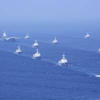 Chinese naval vessels sail in the contested South China Sea during a fleet review in July. In first, Japanese submarine conducts drills in disputed South China Sea