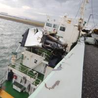 The 2,591-ton tanker Houn Maru is seen stuck aside the bridge connecting Kansai International Airport in Osaka and the mainland after it was driven into the structure by superstrong winds of more than 216 kph on Tuesday. The accident left about 8,000 people stranded overnight on the man-made island that hosts the airport. Typhoon Jebi's superstrong winds of over 216 kph drove tanker into Kansai airport bridge