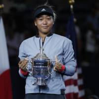Power of diversity: Naomi Osaka holds her trophy after defeating Serena Williams in the women’s final of the U.S. Open tennis tournament on Sept. 8 in New York. Warning to Naomi Osaka: Playing for Japan can seriously shorten your career