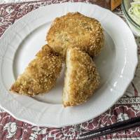 Golden and delicious: Deep-fried potato korokke served with a side salad of cabbage and tomatoes. Potato <I>korokke</I>: Deep-fried, delicious and easy to make