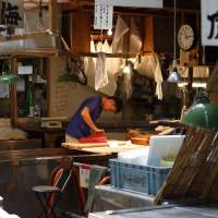 Fresh catch: A fishmonger checks a cut of tuna at the Tsukiji fish market. More than the auction: Tsukiji restaurants to visit before it moves