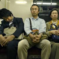 Paying down sleep debt: Passengers doze off while riding on a train in Tokyo. Japan loses sleep over a variety of modern-day issues