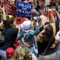 Supporters and protesters scuffle during a rally staged by U.S. President Donald Trump in Tampa, Florida, on July 31 Does corruption matter to voters? It depends