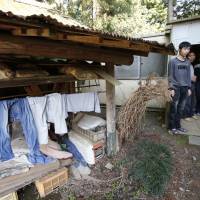 Chinese men participating in the Technical Intern Training Program stand in front of their dormitory in Hokota, Ibaraki Prefecture, in May 2013. The government has expanded this program to fill a severe shortage of unskilled labor. Clear strategy needed for inviting foreign labor