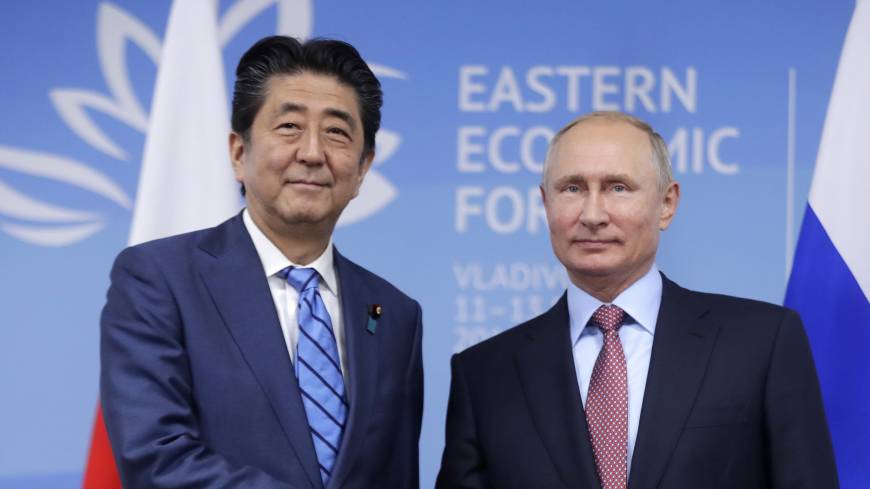 Prime Minister Shinzo Abe and Russian President Vladimir Putin shake hands prior to their talks at the Eastern Economic Forum in Vladivostok, Russia on Sept. 10. Putin's unacceptable peace treaty condition