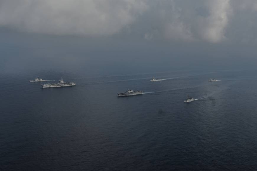 The Maritime Self-Defense Force helicopter carrier Kaga and destroyers Inazuma and Suzutsuki sail with the USS Ronald Reagan aircraft carrier and two other U.S. warships in the South China Sea on Aug. 31. China expands its control in South China Sea