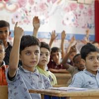 Palestinian students attend a lesson at a school operated by United Nations Relief and Works Agency in the Al-Baqaa Palestinian refugee camp in Jordan last Thursday. The United States, by far the biggest contributor to the agency, announced it was halting its funding for the organization, which it labelled “irredeemably flawed.” Killing the peace process with kindness
