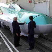 Indian Prime Minister Narendra Modi and Prime Minister Shinzo Abe inspect an E5 series bullet train locomotive at a Kawasaki Heavy Industries plant in Kobe in November 2016. Modi picked Japan as a partner for India’s first high-speed rail line. A strategic framework that works for Japan and India