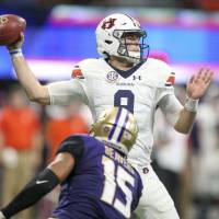 Auburn Tigers quarterback Jarrett Stidham (8) throws a pass against the Washington Huskies in the first quarter at Mercedes-Benz Stadium in Atlanta on Saturday. No. 9 Auburn scores late, beats No. 6 Washington 21-16