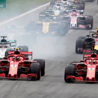 Ferrari’s Sebastian Vettel (right) and Kimi Raikkonen lead the pack at the start of the Italian Grand Prix on Sept. 2, in Monza, Italy. Ferrari, Mercedes prepare for battle