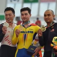 Silver medalist Yudai Nitta (left) poses with gold medalist Jai Angsuthasawit (center) and Mohd Azizulhasni Awang, the bronze medalist, after the men’s keirin competition during the Asian Games on Friday in Jakarta. Yudai Nitta making most of chance at Asian Games