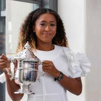 Naomi Osaka poses with her championship trophy at the Top of the Rock Observation Deck at Rockefeller Center in New York on Sunday, the day after defeating Serena Williams to win the 2018 U.S. Open. Kimiko Date tips Naomi Osaka as future No. 1