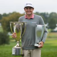 Keegan Bradley holds the championship trophies after winning the BMW Championship in a playoff on Monday at Aronimink. Keegan Bradley wins BMW title in playoff with Justin Rose; Hideki Matsuyama qualifies for Tour Championship