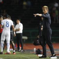 Cambodia general manager Keisuke Honda gives instructions during the friendly match between Cambodia and Malaysia in Phnom Penh on Monday. Malaysia won 3-1. Honda's debut as general manager of Cambodia ends in loss