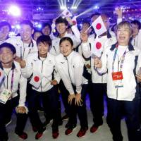 Swimmer Rikako Ikee (center) poses with other members of the Japanese delegation during the closing ceremony of the Asian Games on Sunday in Jakarta. Rikako Ikee promises to keep working as Asiad ends