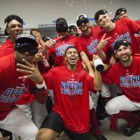 The Indians celebrate in the clubhouse after becoming the first MLB club to clinch a division title this season on Saturday in Cleveland. Indians rout Tigers to clinch third straight AL Central title