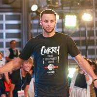 Golden State Warriors superstar Steph Curry exchanges greeting with fans at an event in Tokyo on Wednesday. Steph Curry sweeps into Tokyo on tour of Asia