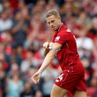 Liverpool’s Jordan Henderson puts on the captain’s armband on Aug. 12. Liverpool captain Jordan Henderson signs contract extension