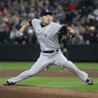 New York starter Masahiro Tanaka pitches against Seattle in the first inning on Friday night. Yankees' Masahiro Tanaka dazzles in 10-strikeout performance against Mariners